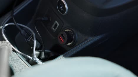 Plugging-a-USB-charging-device-and-cable-into-a-car-cigarette-lighter-port