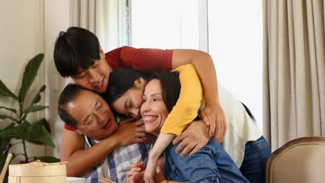 family hugging and smiling together at home, enjoying quality time