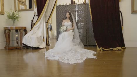 bride sitting as she is being photographed while she waits