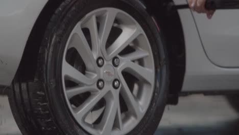 professional worker cleaning a car tire thoroughly. slow motion