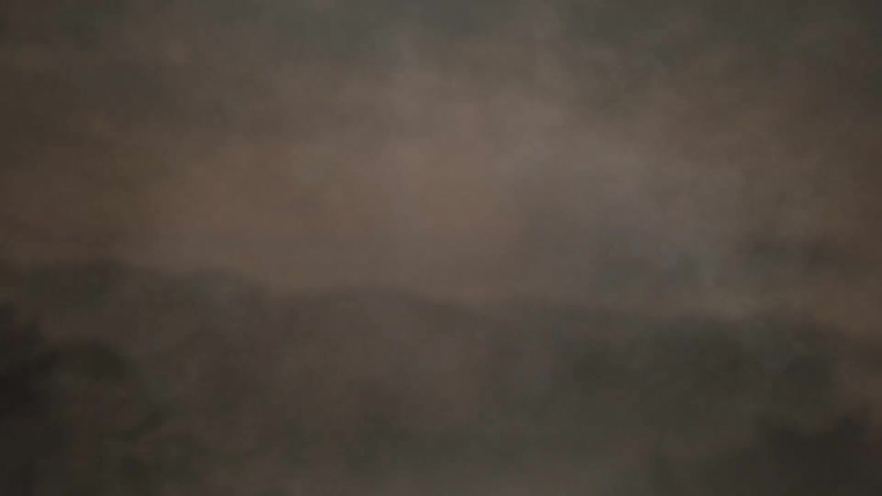 Animation of grey smoke over mountains