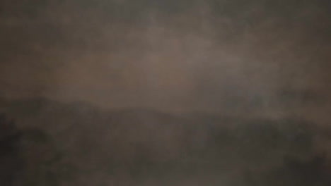 animation of grey smoke over mountains