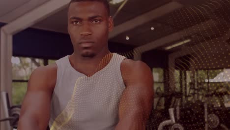 animation of glowing spots over man exercising in gym