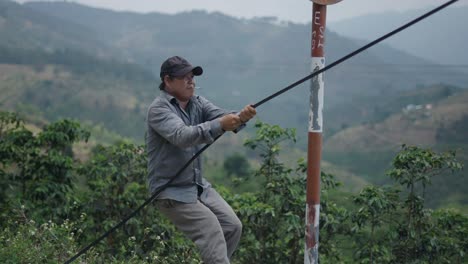 man installing cable in rural mountains