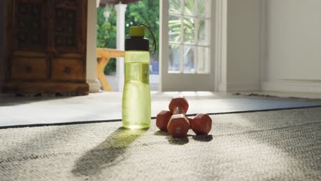 video of bottle of water, weights and yoga mat prepared for exercising at home