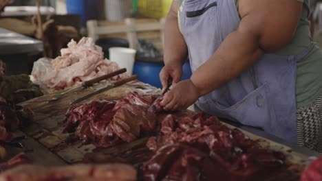 african woman cutting the meat