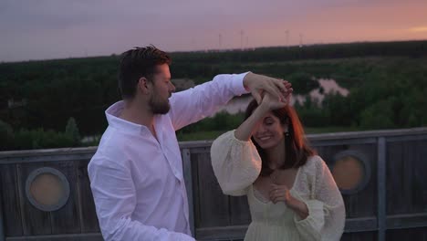 Couple dancing on the sahara tower in Lommel, Belgium at sunset.