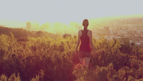 hiking, sunset and city with woman in mountains