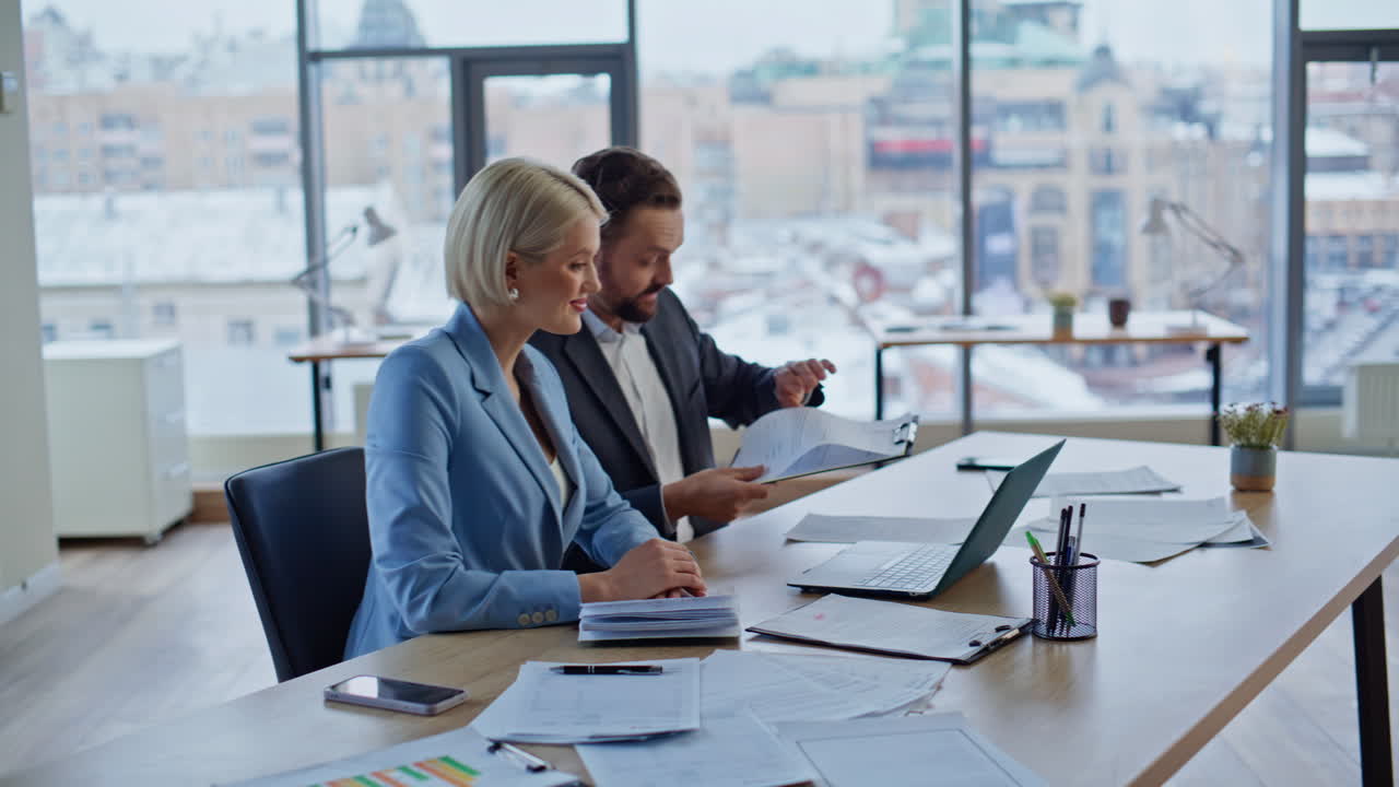 Productive coworkers speaking remotely watching computer in panoramic workspace