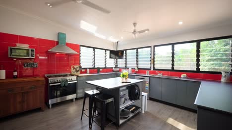 a bold red kitchen interior with modern appliances and minimalist design in a contemporary home. interior of house home staged for real estate.