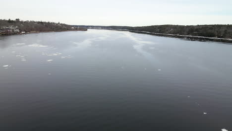 aerial left to right motion over kennebec river to reveal pilot tug boat