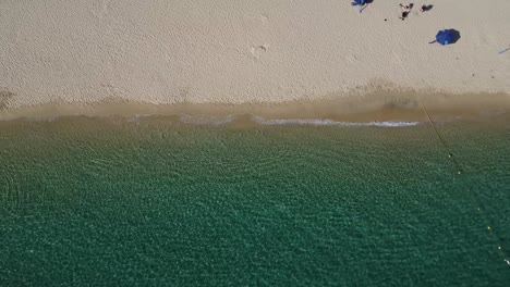 Descending-view-of-Santa-Maria-Beach-with-clear-waters,-Cabo-San-Lucas