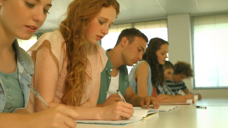 Students-taking-notes-in-lecture