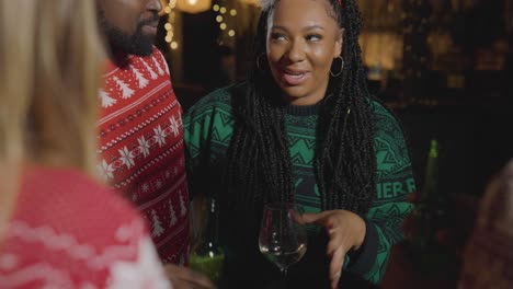 Tracking-Shot-Approaching-a-Small-Group-of-Friends-Celebrating-Christmas-at-a-Bar