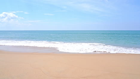 slow-motion of large waves hitting the sands of a tropical beach