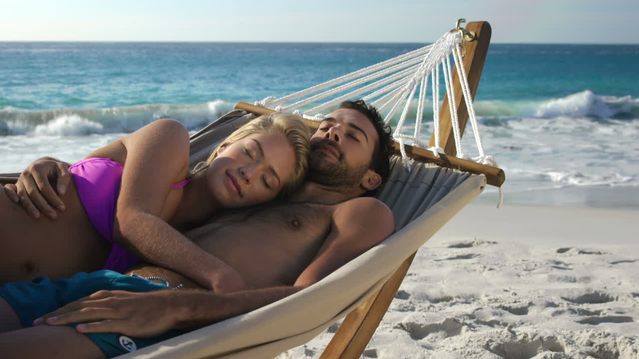 Couple relaxing in hammock 