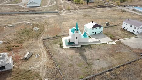 aerial: small mosque is shining in sunrise.