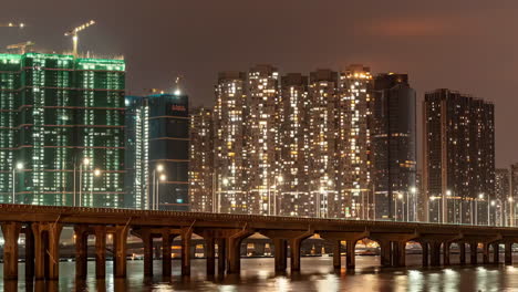 nighttime cityscape with bridge and illuminated buildings