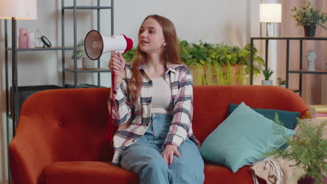 Young-woman-shout-in-megaphone-loudspeaker-announces-discounts-sale-of-real-estate-at-home-on-sofa