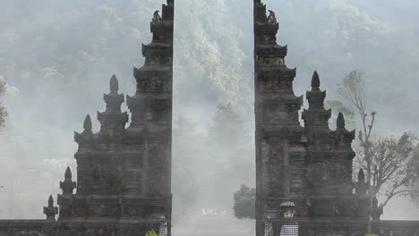 the fog drifts by a traditional balinese temple gate in bali indonesia 1