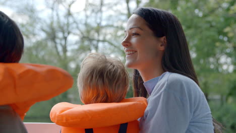 Mother-And-Sons-Enjoy-Ride-In-River-Boat-Shot-In-Slow-Motion