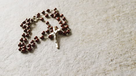 close up of rosary on white background with copy space