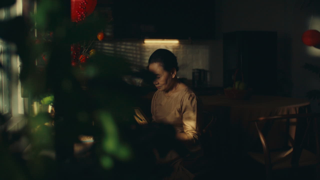 Elderly Woman Reading in a Kitchen