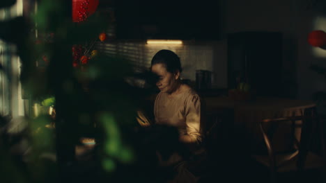 elderly woman reading in a kitchen