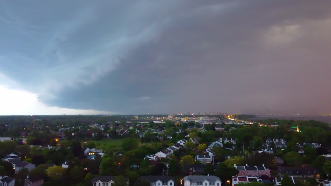 Aerial view from coming storm above highway and neighborhoods of Montreal, Canada.