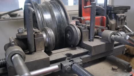 close-up of an alloy wheel rim repair machine in operation