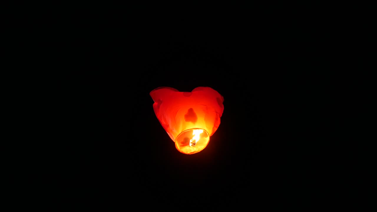 Heart Shape Lantern Flying In The Night Sky. Chinese Flying Paper Lantern