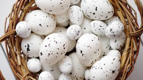 basket of white dotted easter eggs in brown wicker basket