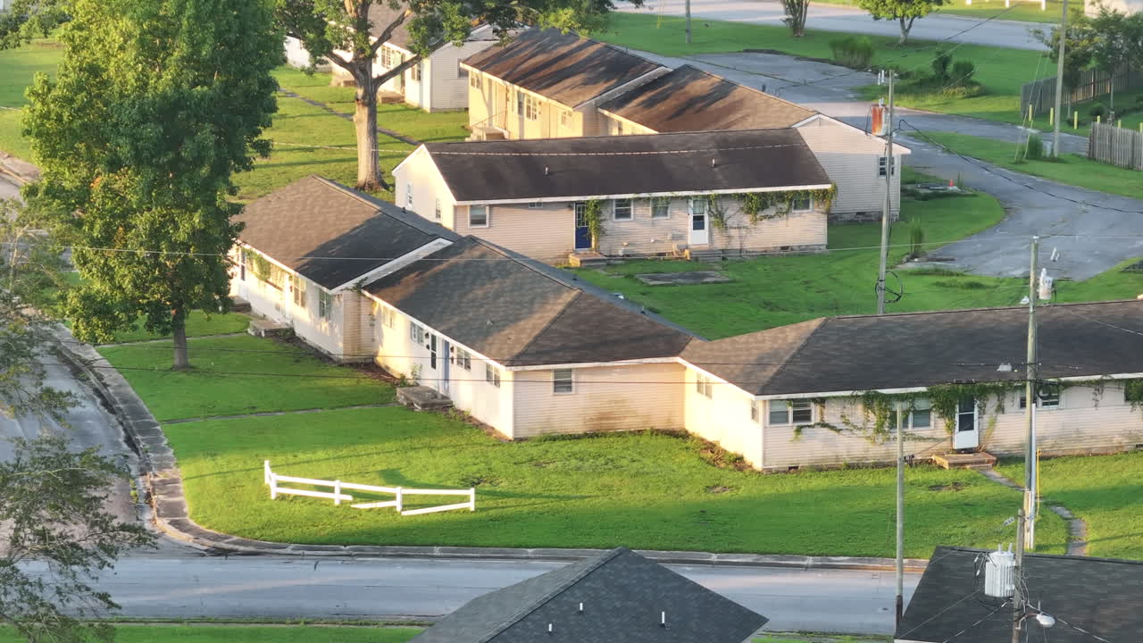 Cinematic drone shot of abandoned apartments with vegetation growing on the buildings, flying over medium shot aerial footage
