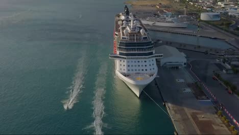 aerial view of two jet skies sailing in front of a cruise ship and the camera panning down to get a overview of the jet skies sailing by