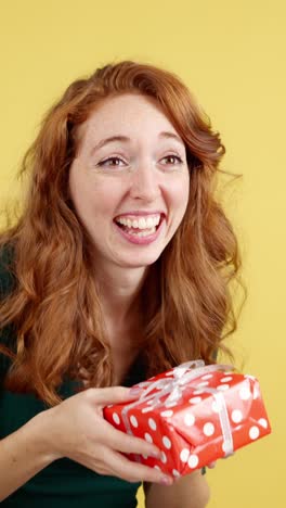 happy woman with red hair receiving a gift