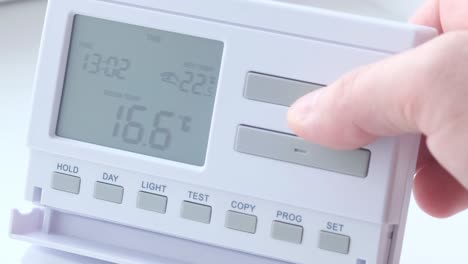 close-up of a thermostat display being adjusted