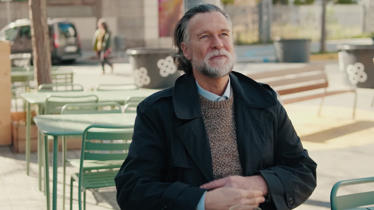 Contemplative Senior Man in an Outdoor Cafe