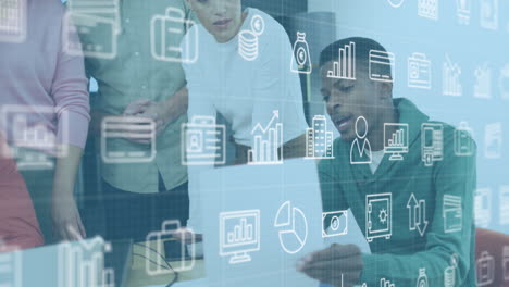Animation of digital icons over african american man with a document discussing with colleagues
