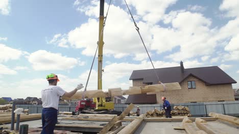 log house construction with crane