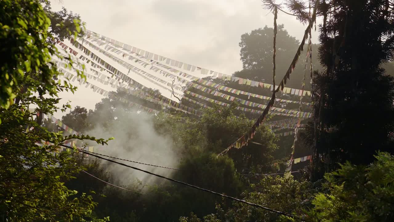 Prayer Flags in the Forest at Sunrise at Monkey Temple in Kathmandu in Nepal, Bright Colourful Buddhist Prayer Flags in Misty Morning Scenery with Bright Colorful Colors at the Sacred Holy Temple