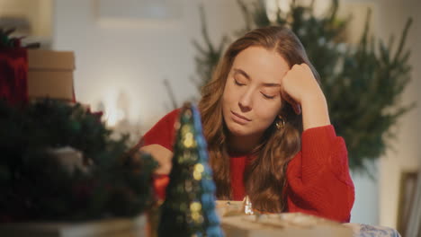 Woman-with-head-in-hands-sitting-at-table