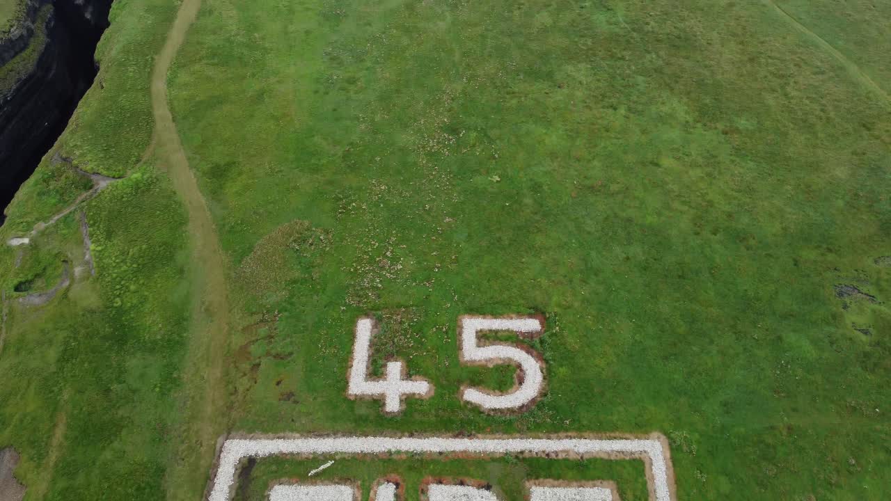 Drone reveal shot of the WW2 marker to the lighthouse at Loop Head Clare Ireland