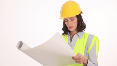 female engineer or architect examining blueprints