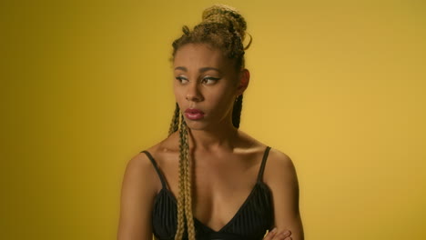 Offended-woman-with-crossed-arms-on-chest-looking-into-camera-in-studio