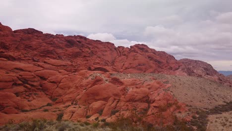 wide gimbal panning shot of the bright red sandstone rock formations in red rock canyon, nevada