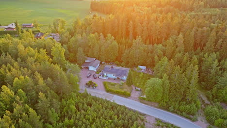 AERIAL:-Private-house-with-solar-cells-and-EV-cars-on-the-yard,-sunny-morning