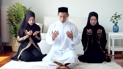 young islamic people praying with reading the quran