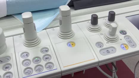 view of sticks and buttons on the control panel of hospital scanning system