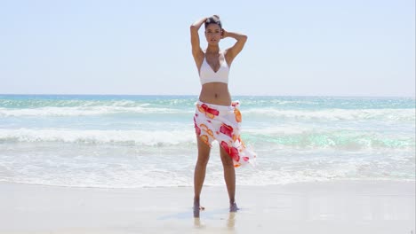 Sexy-young-woman-walking-through-the-surf