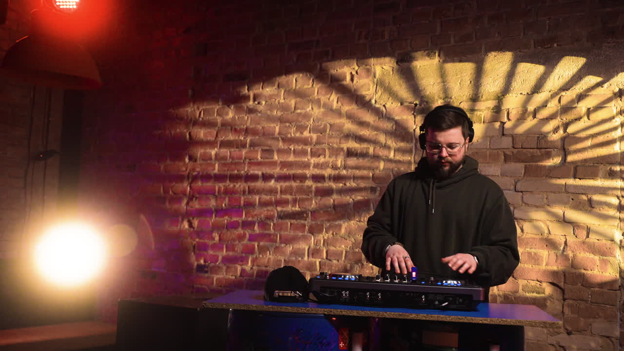 Man with black cap djing at the disco